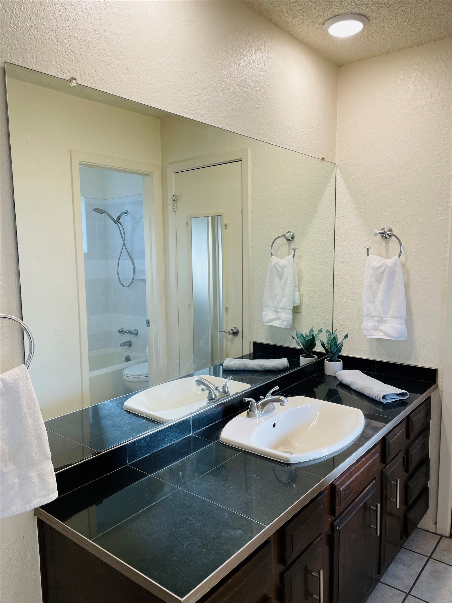 3908 Holt Drive Austin, TX 78749 - Photo 7 of 22 Bathroom with a high ceiling, new recessed lighting, vanity, shower / tub combination, and light tiled floors