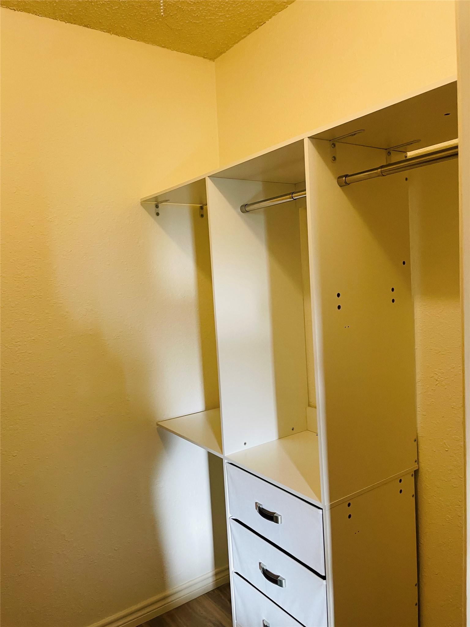 3908 Holt Drive Austin, TX 78749 - Photo 9 of 22 Walk in closet with wood finished floors and customized built-ins in primary bedroom (one of 3 closets)