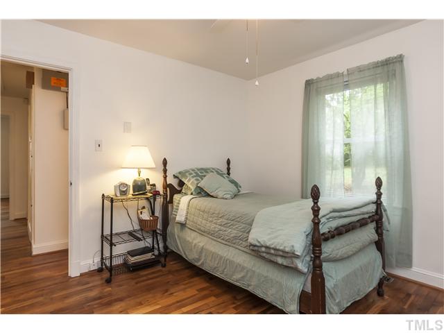 702 Van Buren Road Raleigh, NC 27604 - Photo 14 of 18 Second bedroom with ceiling fan and hardwood flooring.