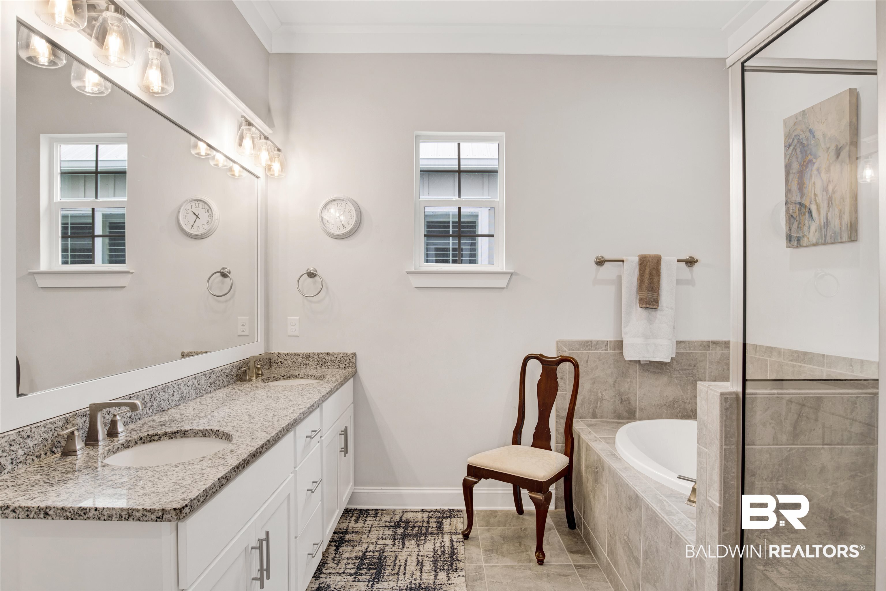 23893 Cypress Crossing Orange Beach, AL 36561 - Photo 11 of 22 Bathroom with double vanity, a bath, healthy amount of natural light, tile patterned flooring, and ornamental molding