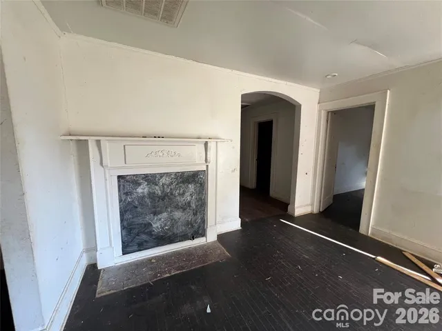 a view of an empty room and fire place