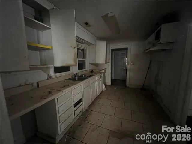 a kitchen with a sink and cabinets