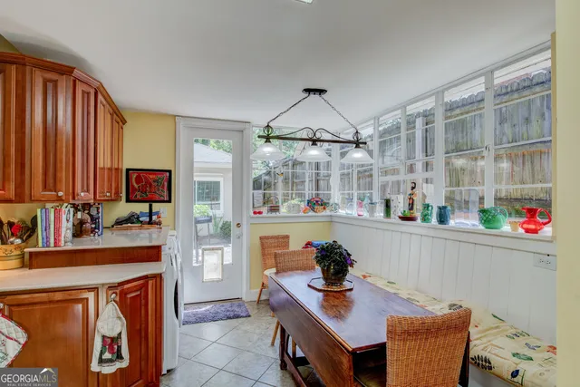 a room with furniture a chandelier and a wooden floor