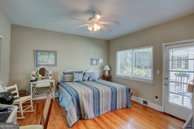 a bedroom with a bed and a lamp next to a window
