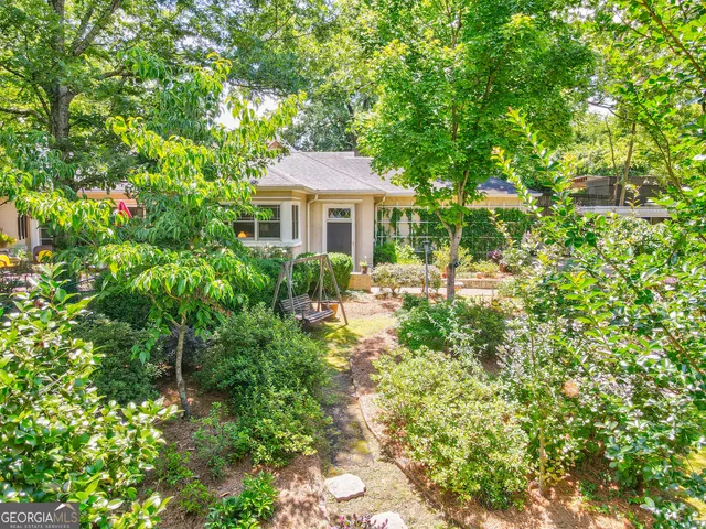 a view of backyard of house with green space