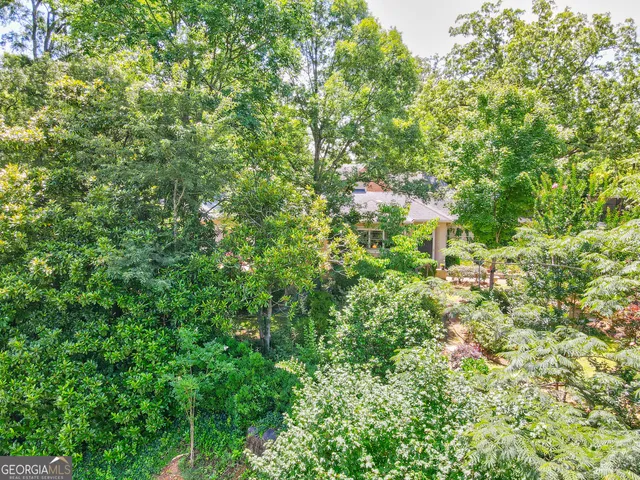 an aerial view of a house with a yard and garden