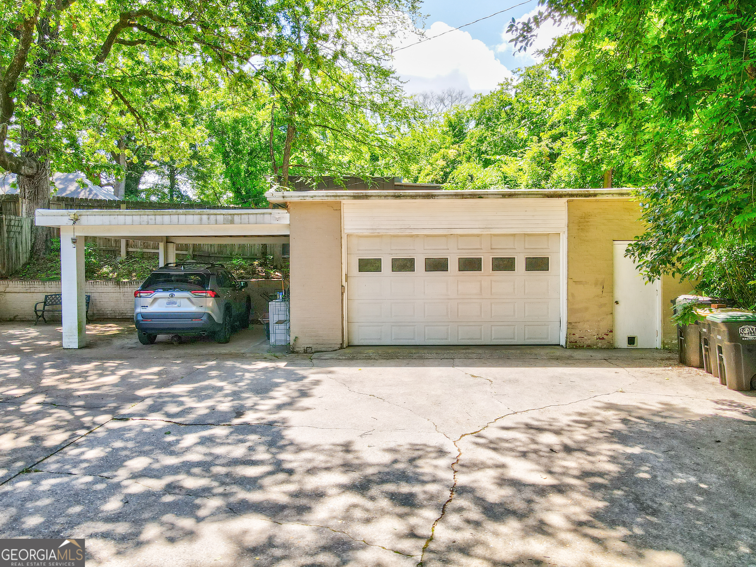 31 Notasulga Drive Rome, GA 30161 - Photo 36 of 38 a car parked in front of a white house with large trees
