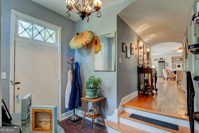 a view of a dining room with furniture and a chandelier