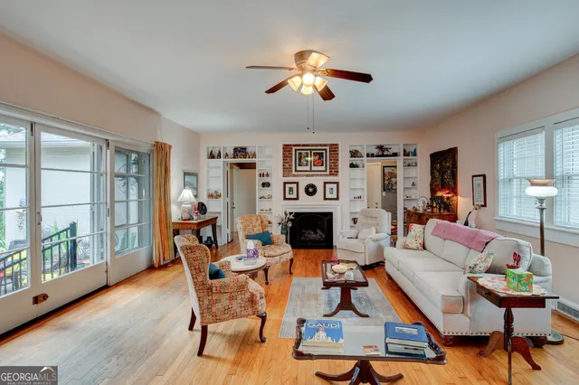a living room with furniture a fireplace and a large window