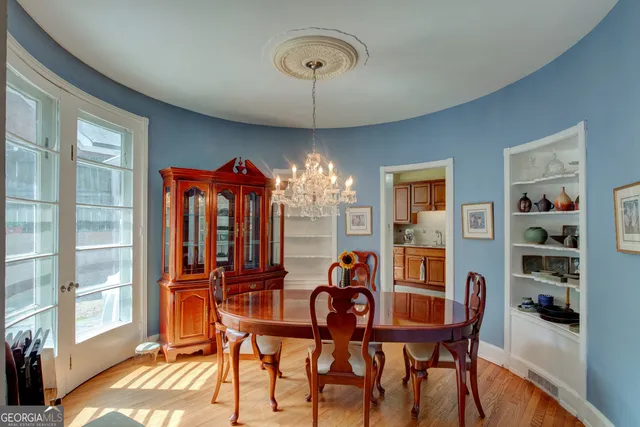 a view of a dining room with furniture and chandelier