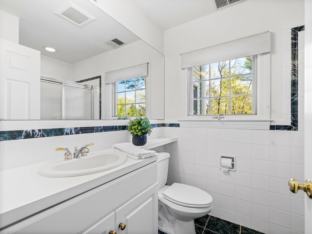 14 Moccasin Path Natick, MA 01760 - Photo 24 of 34 a bathroom with a sink toilet and a mirror