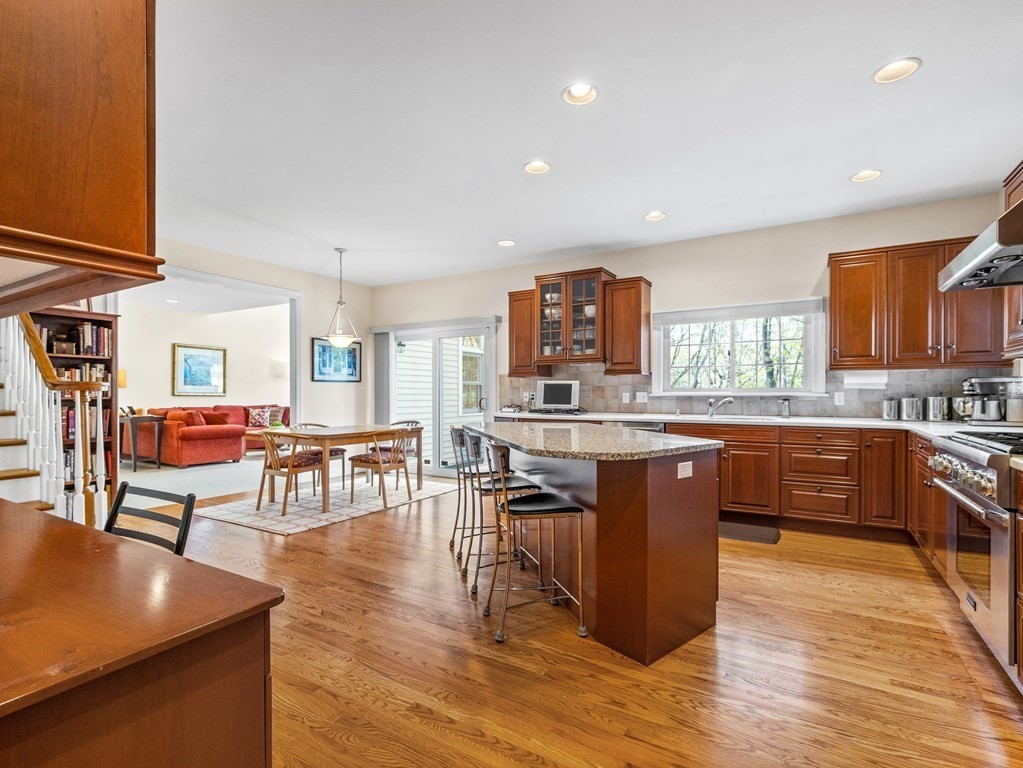14 Moccasin Path Natick, MA 01760 - Photo 7 of 34 a kitchen with stainless steel appliances granite countertop wooden floors and wooden cabinets