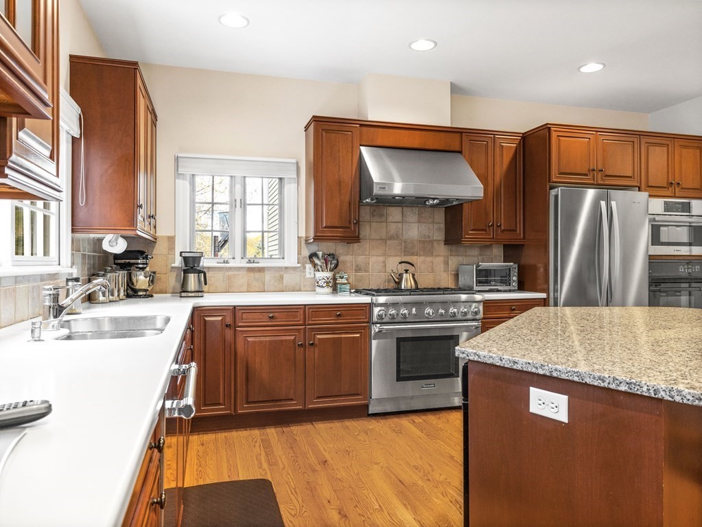 14 Moccasin Path Natick, MA 01760 - Photo 10 of 34 a kitchen with stainless steel appliances granite countertop a sink a stove and a refrigerator