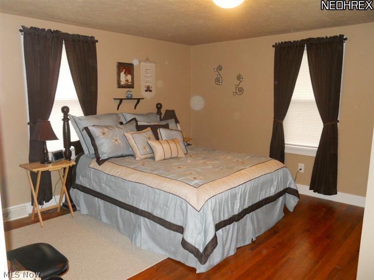 17540 Kinsman Road Middlefield, OH 44062 - Photo 10 of 16 1st floor Master bedroom offers wood floors, 2 double closets and updated 1/2 bath
