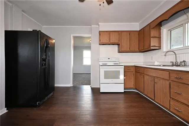 a kitchen with a refrigerator sink and cabinets
