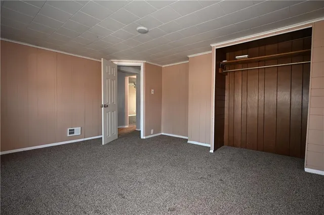 an empty room with closet area
