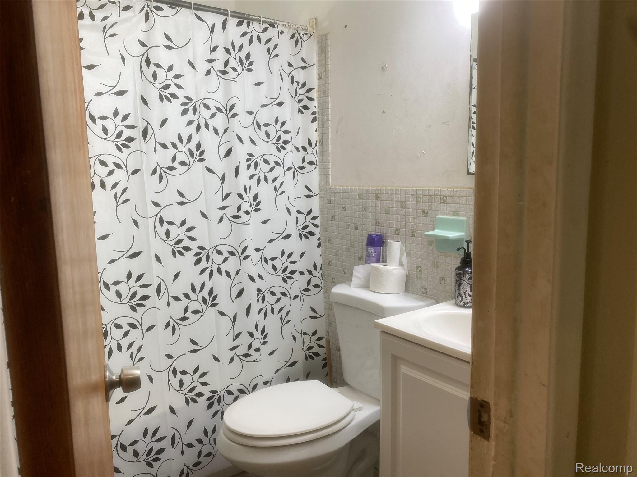 180 West Rutgers Avenue Pontiac, MI 48340 - Photo 21 of 33 Full bath with tile walls, vanity, and a shower with curtain