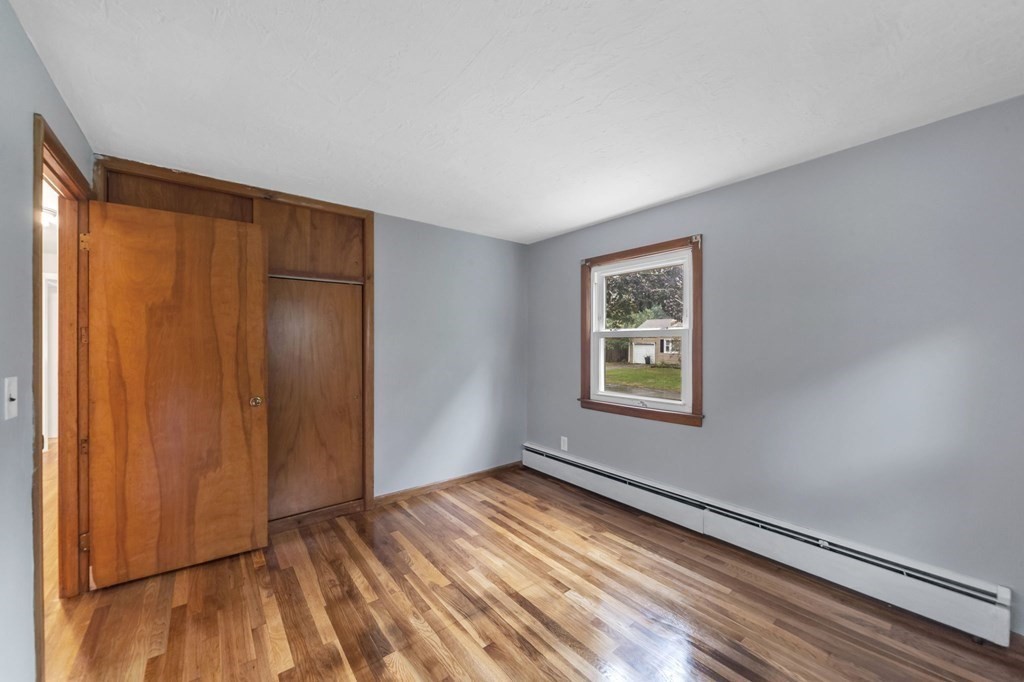 99 Bacon Road Springfield, MA 01119 - Photo 15 of 28 a view of an empty room with window and wooden floor