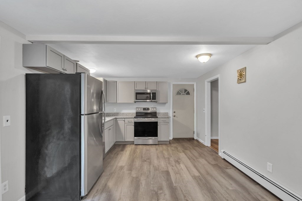 99 Bacon Road Springfield, MA 01119 - Photo 6 of 28 a kitchen with a refrigerator and a stove top oven