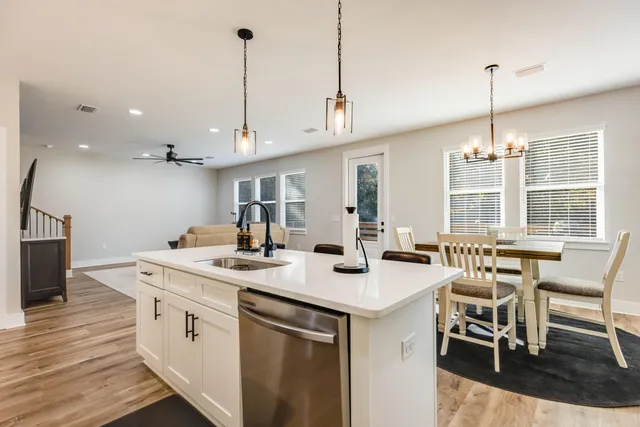 a view of a dining table chairs and chandelier