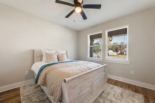 a bedroom with a bed and a ceiling fan
