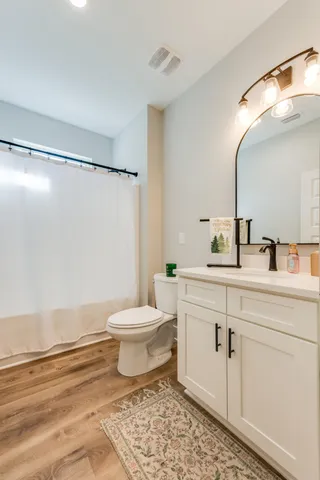 a bedroom with a large bed and a flat screen tv