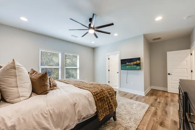 a bathroom with a white bath tub a shower and a sink