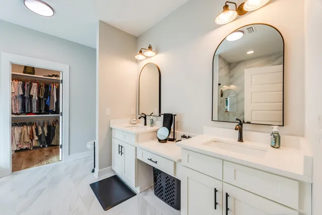 a view of walk in closet with clothes