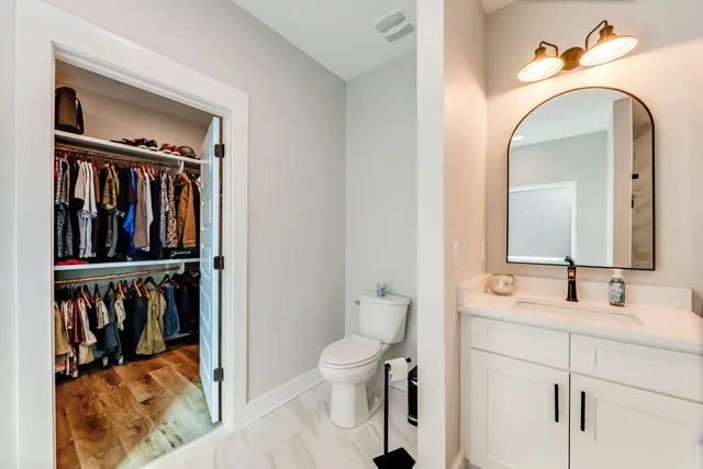 a bedroom with a bed and ceiling fan