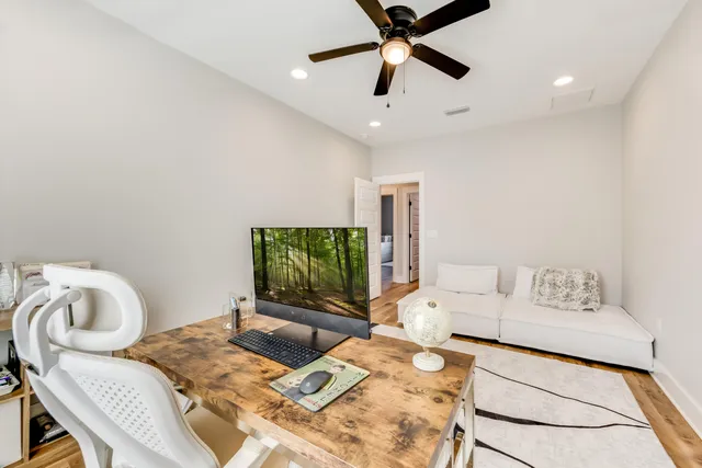 a view of a house with patio and wooden fence