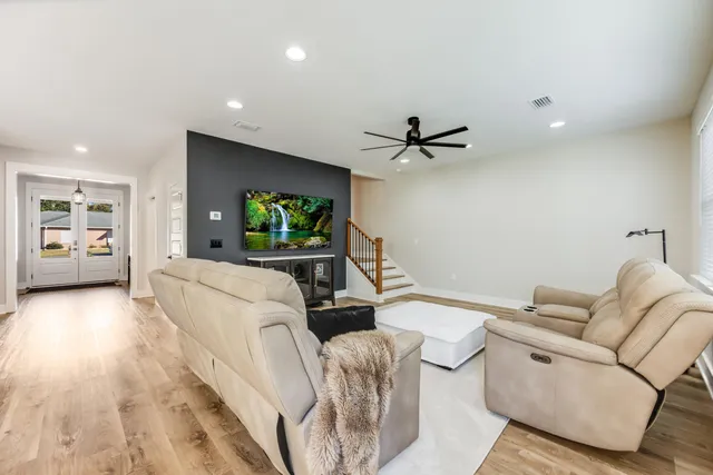 a living room with furniture and a flat screen tv