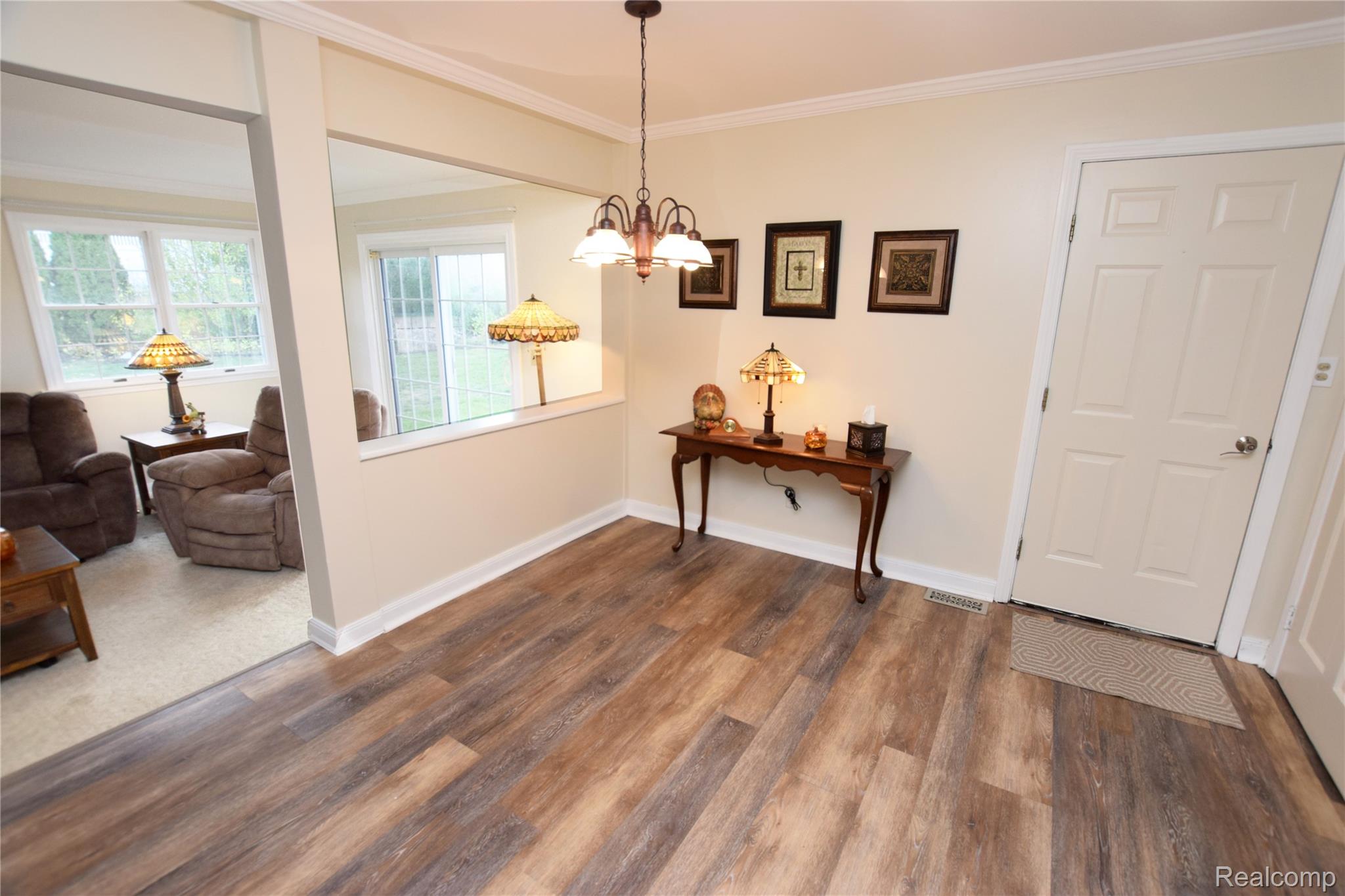 15489 Linden Road Linden, MI 48451 - Photo 6 of 25 Foyer entrance featuring ornamental molding, a chandelier, and dark wood-type flooring