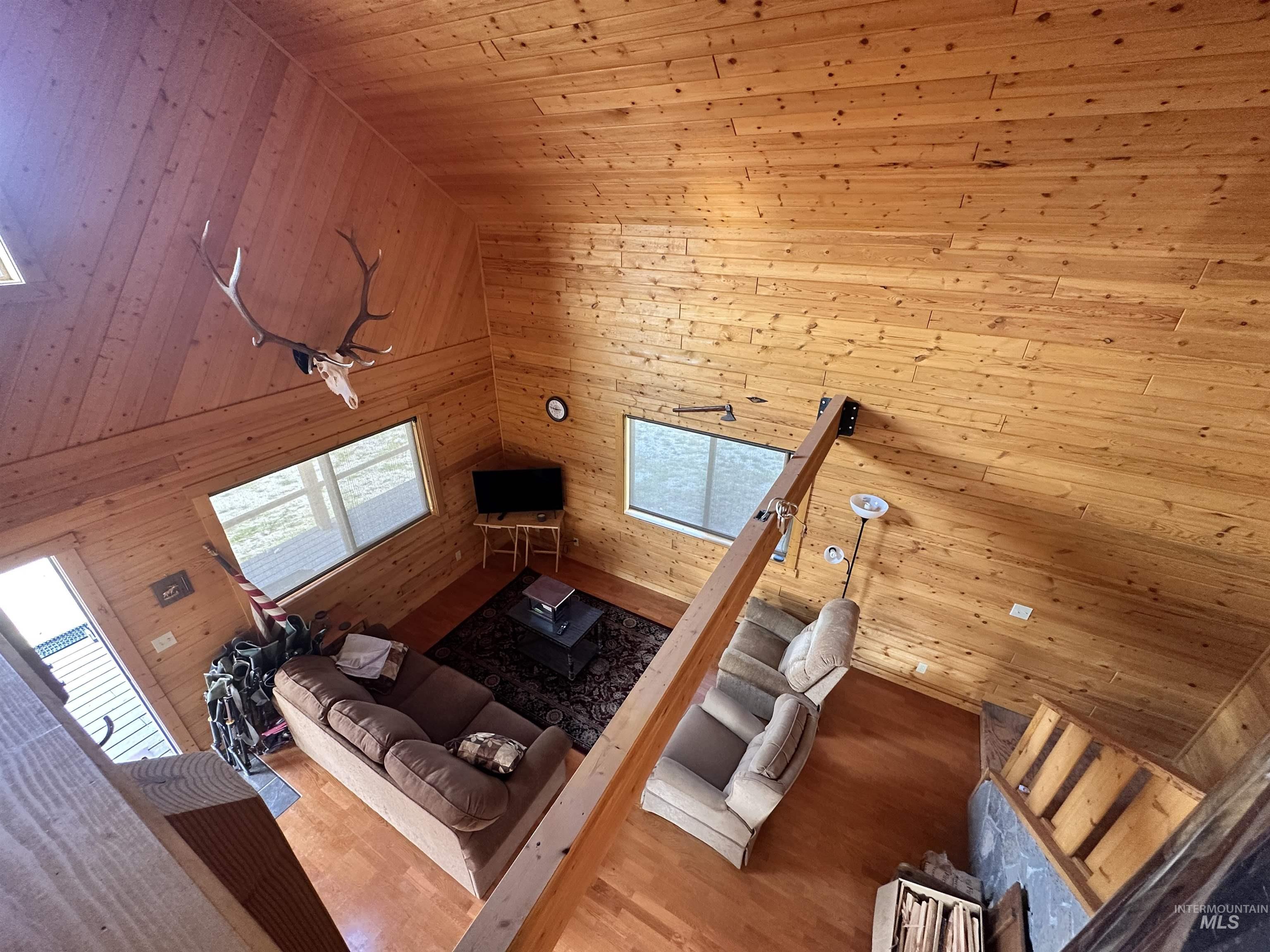532 Warren Creek Road McCall, ID 83638 - Photo 26 of 45 Living area featuring wooden walls, wood ceiling, and wood finished floors