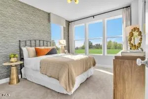 a bed sitting in a bedroom next to a window