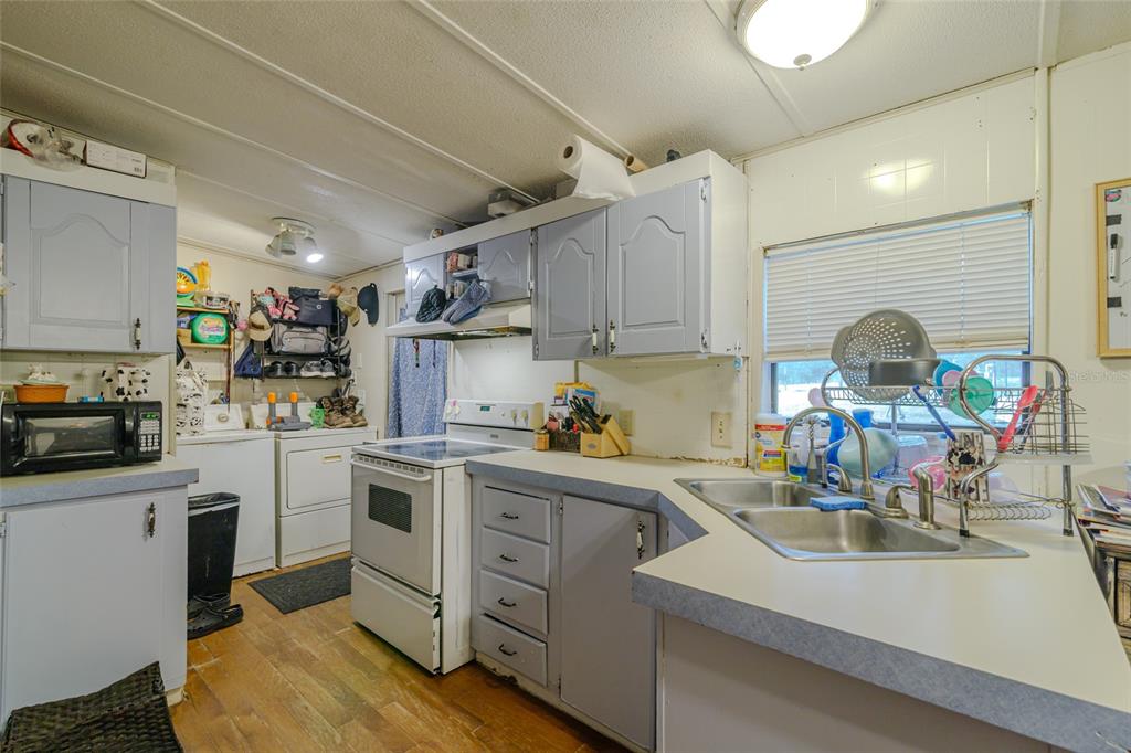 4225 Southwest 178th Terrace Dunnellon, FL 34432 - Photo 23 of 49 a kitchen with a sink appliances cabinets and furniture