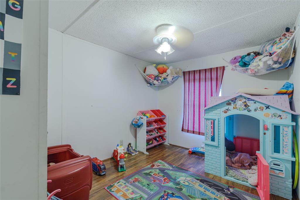 4225 Southwest 178th Terrace Dunnellon, FL 34432 - Photo 34 of 49 a bed room with a bed and a chandelier