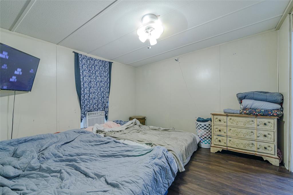 4225 Southwest 178th Terrace Dunnellon, FL 34432 - Photo 36 of 49 a bedroom with a bed and a chandelier