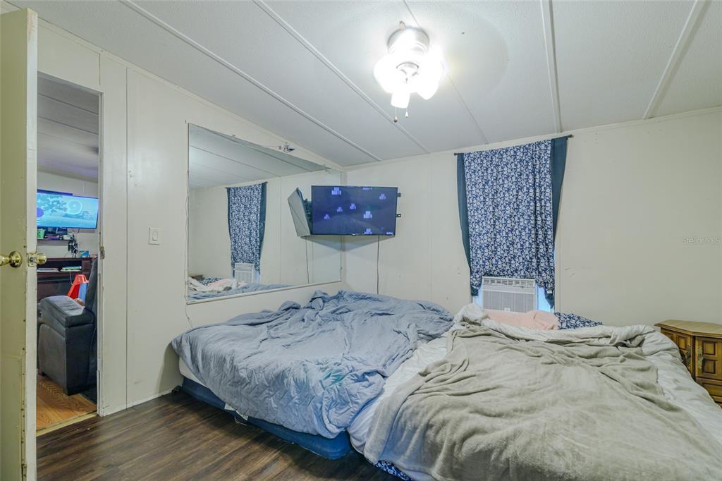 4225 Southwest 178th Terrace Dunnellon, FL 34432 - Photo 37 of 49 a bedroom with a large bed and a chandelier