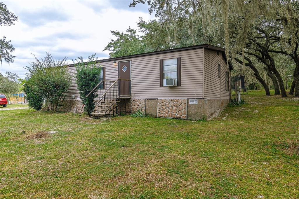 4225 Southwest 178th Terrace Dunnellon, FL 34432 - Photo 4 of 49 a backyard of a house with lots of green space