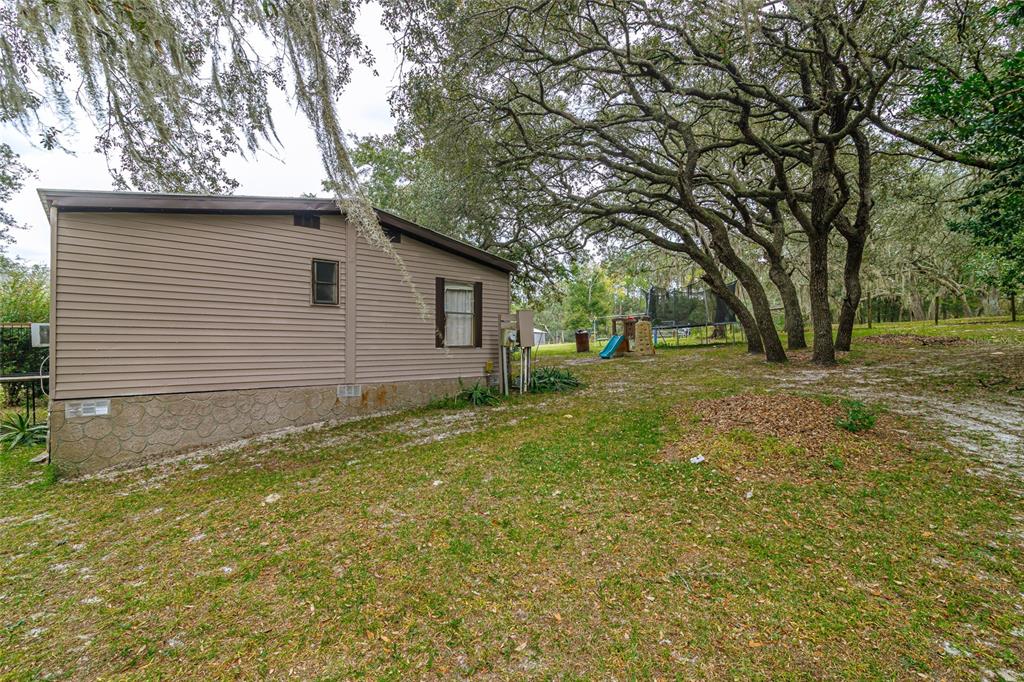 4225 Southwest 178th Terrace Dunnellon, FL 34432 - Photo 5 of 49 a backyard of a house with large trees