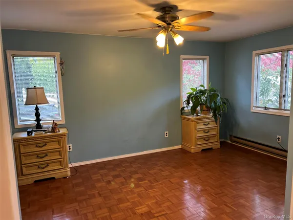 an empty room with windows and closet