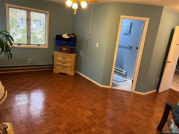 a view of room with window and a wooden floor