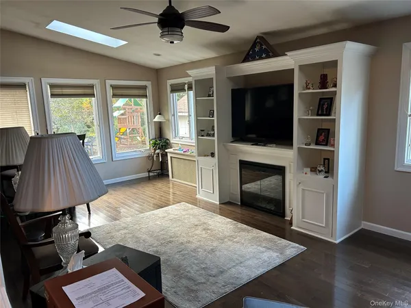 a living room with furniture fireplace and flat screen tv