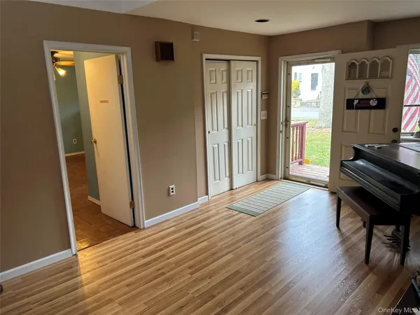 a bedroom with wooden floor and a window