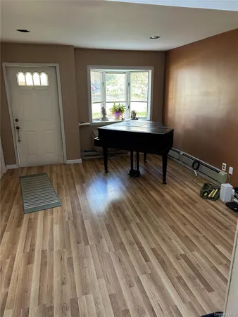 a room with wooden floor and furniture