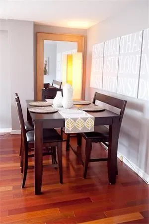 a view of a dining room with furniture window and wooden floor