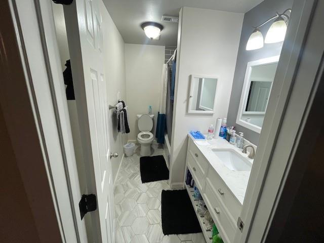 4245 Madera Road Irving, TX 75038 - Photo 9 of 10 Full bathroom with vanity, light tile patterned floors, and curtained shower