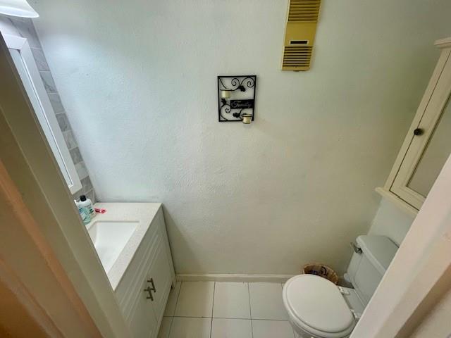 4245 Madera Road Irving, TX 75038 - Photo 10 of 10 Half bathroom featuring vanity and light tile patterned floors