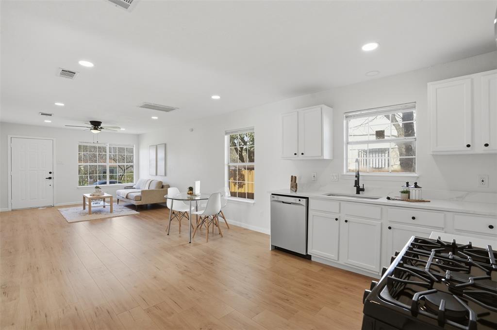 2012 Tennessee Avenue Dallas, TX 75224 - Photo 11 of 28 a kitchen that has a lot of cabinets wooden floor and stainless steel appliances