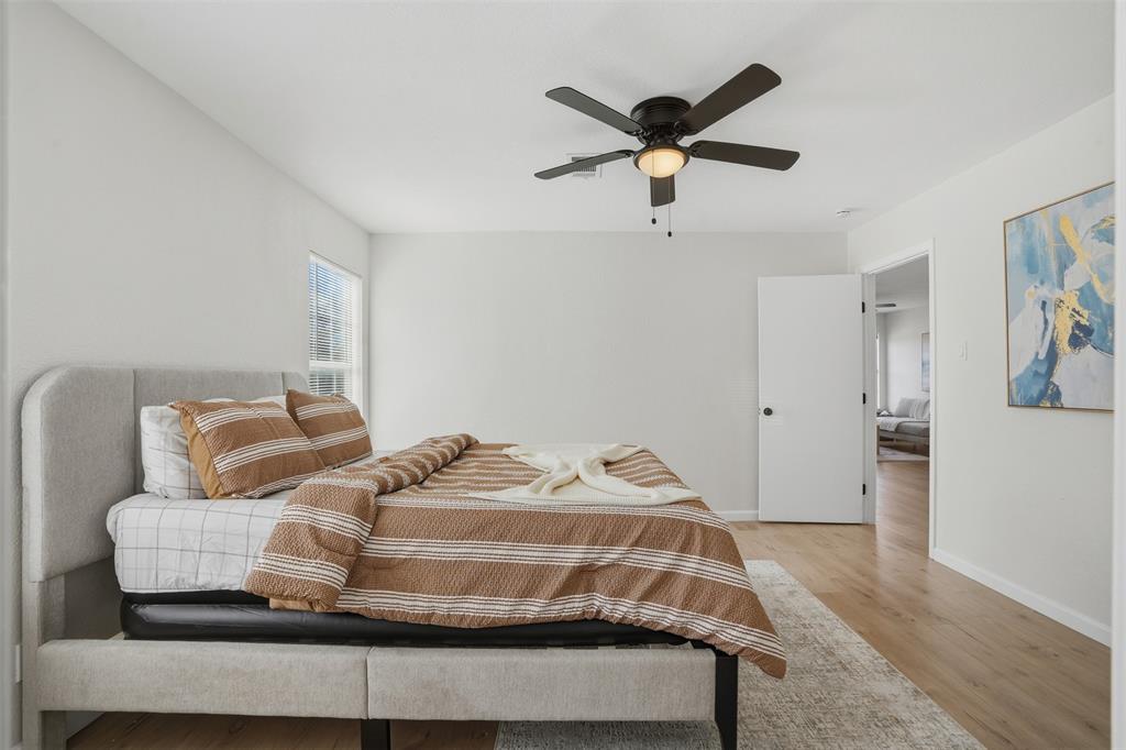 2012 Tennessee Avenue Dallas, TX 75224 - Photo 13 of 28 a bedroom with a bed and wooden floor